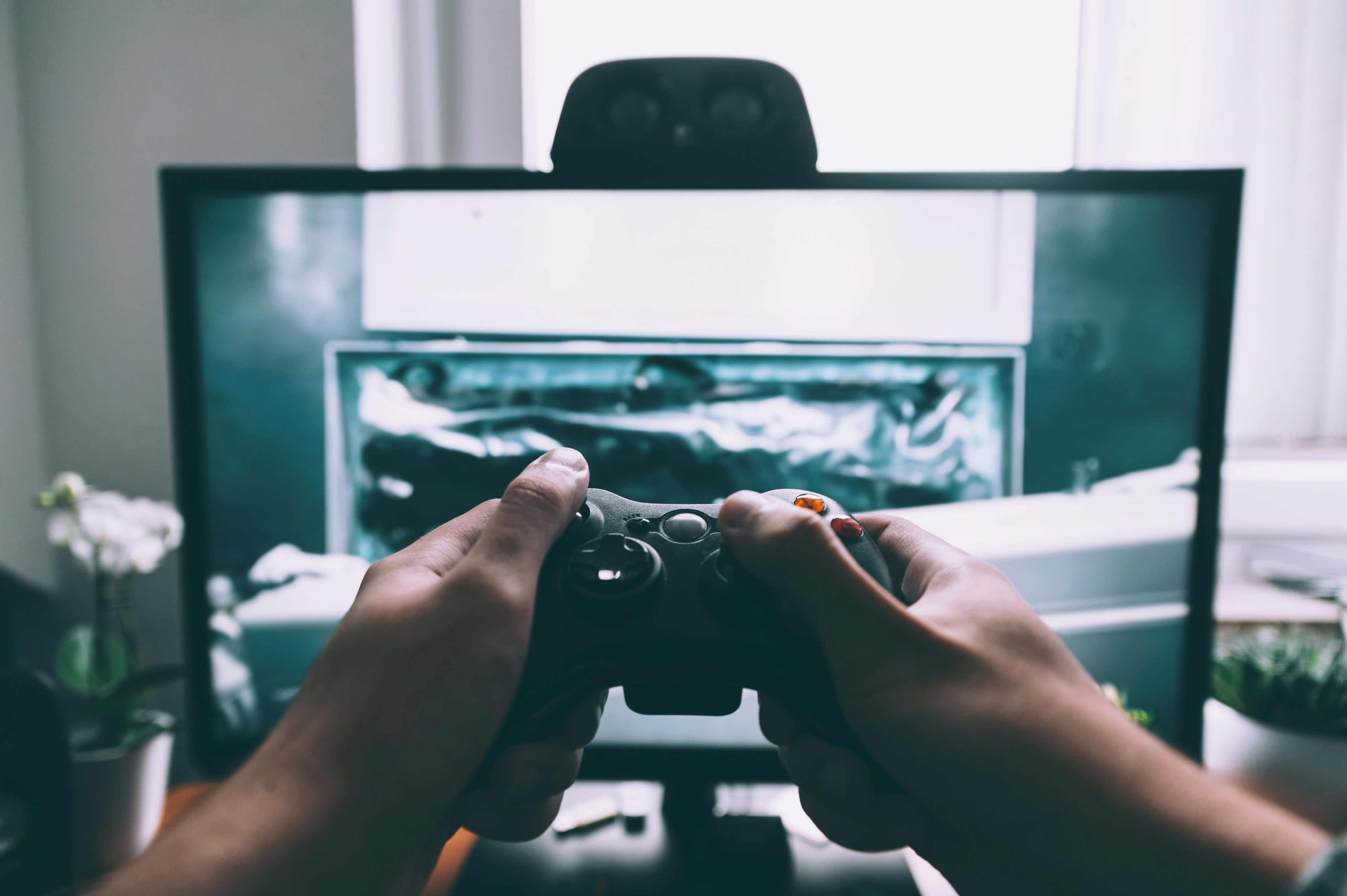person using computer playing FPS game